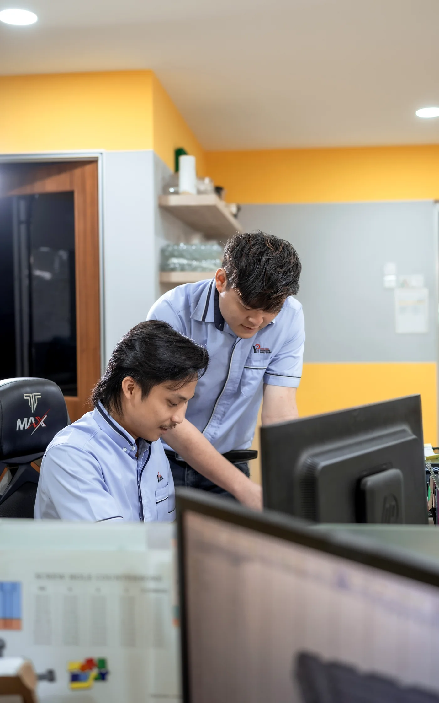 Yong Heng designers working on mold design at the R&D workstations.