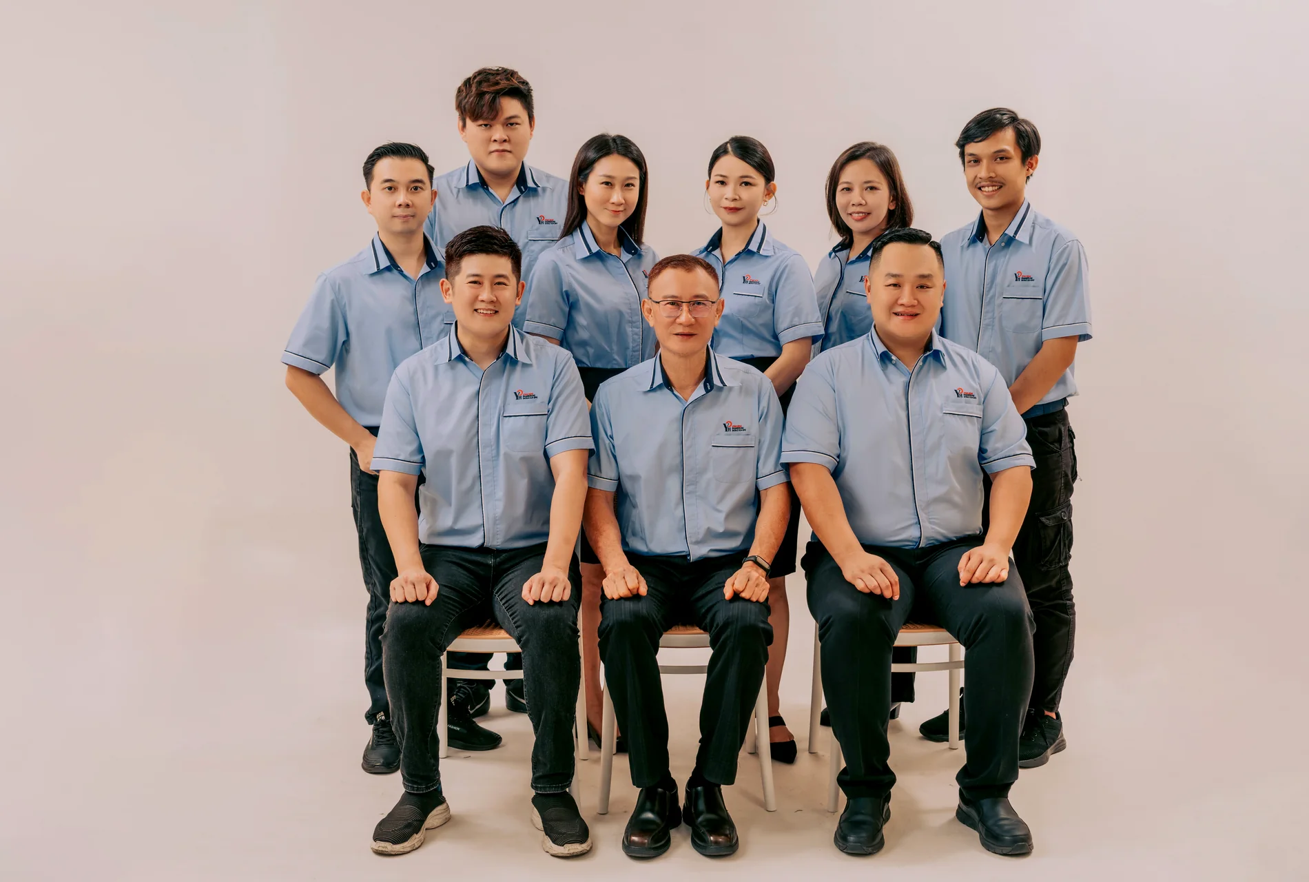 The Yong Heng Engineering Works team: nine people in company uniform.